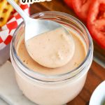 Spoon dipping into a jar of homemade burger sauce