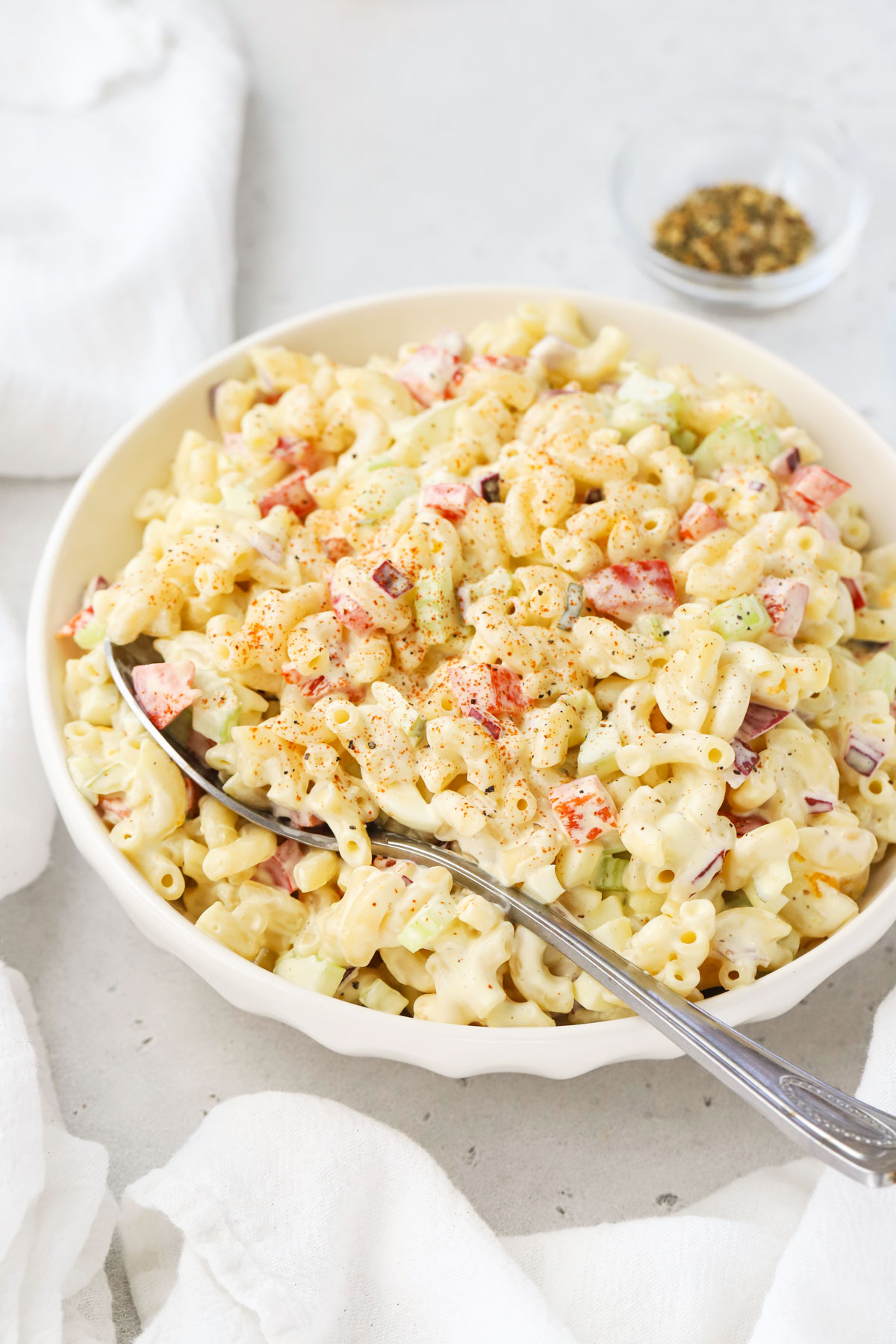 A serving bowl of gluten-free macaroni salad with creamy dressing