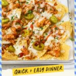 Sheet pan of BBQ Chicken Nachos drizzled with BBQ sauce