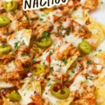 Sheet pan of BBQ Chicken Nachos drizzled with BBQ sauce