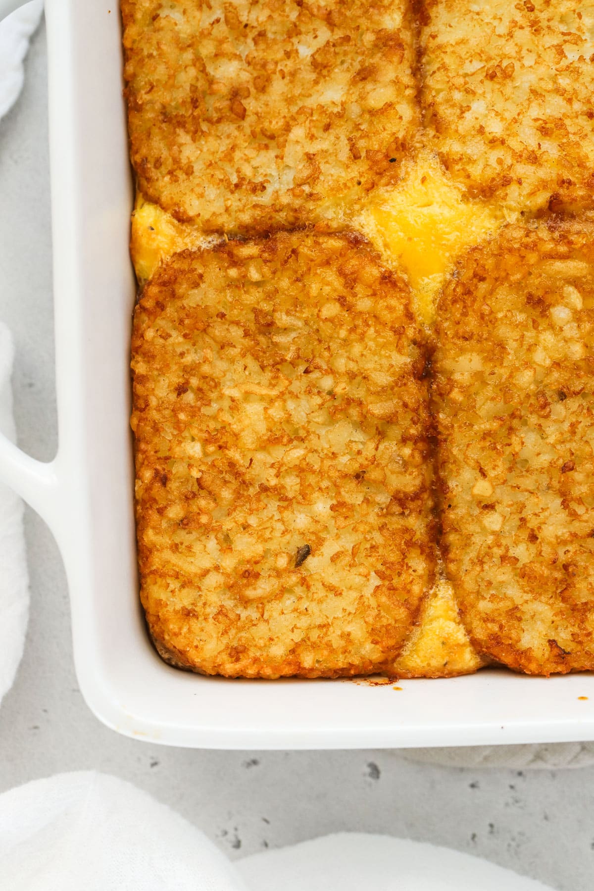 Sausage egg casserole topped with hash brown patties