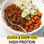 Sloppy joe bowls with sloppy joe beef, roasted sweet potatoes, creamy coleslaw, and dill pickles