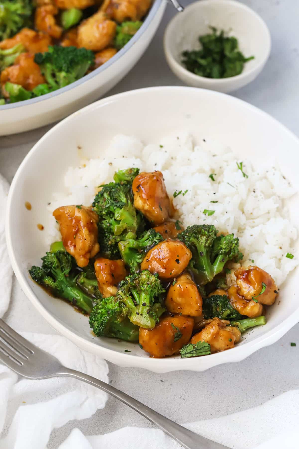 A bowl of chicken and broccoli stir fry over rice